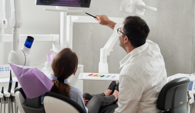 Dental patient reviewing XRAY with dentist