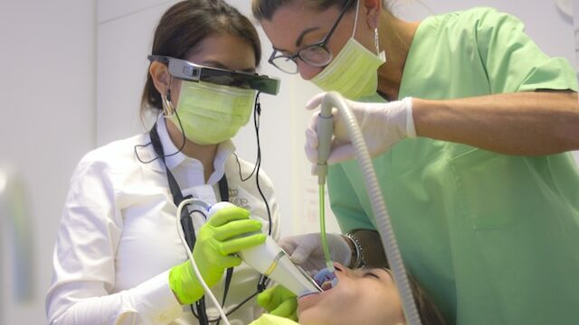 Dentist and dental nurse working on a patient