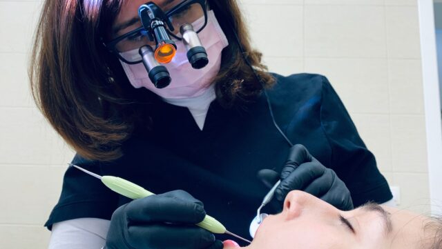 a dental technician working on a patient